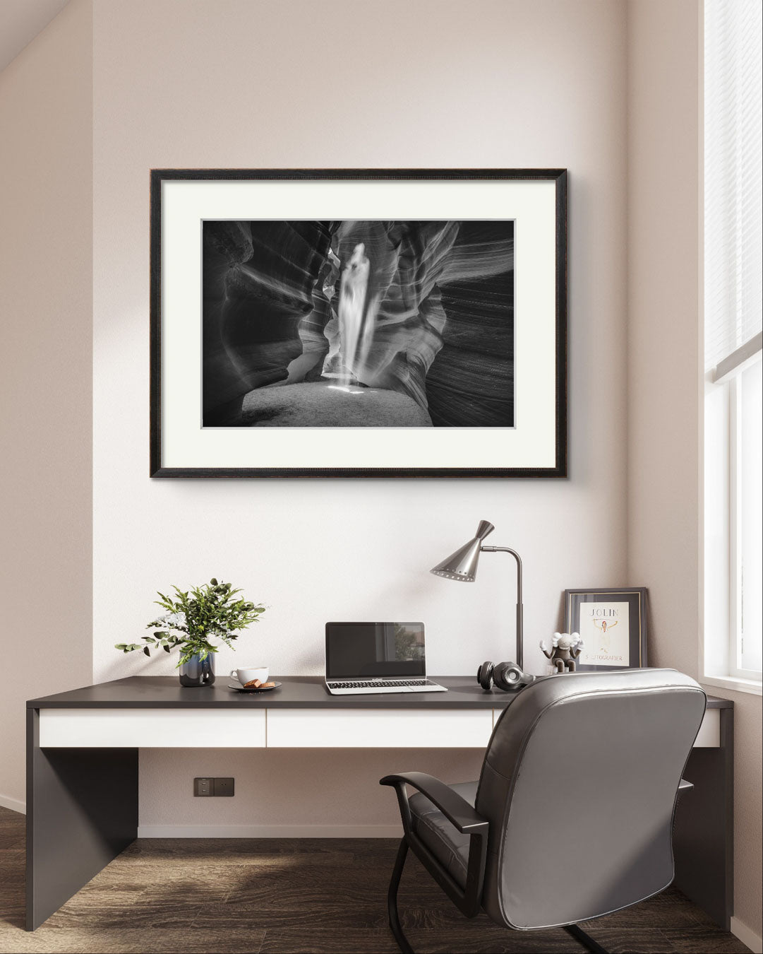 ACEO office with a desk and chair. on the wall you can see a black and white photograph of a canyon passage with sand threw in the air in a shape of a ghost. Antelope Canyon. Navajo. Page. Arizona