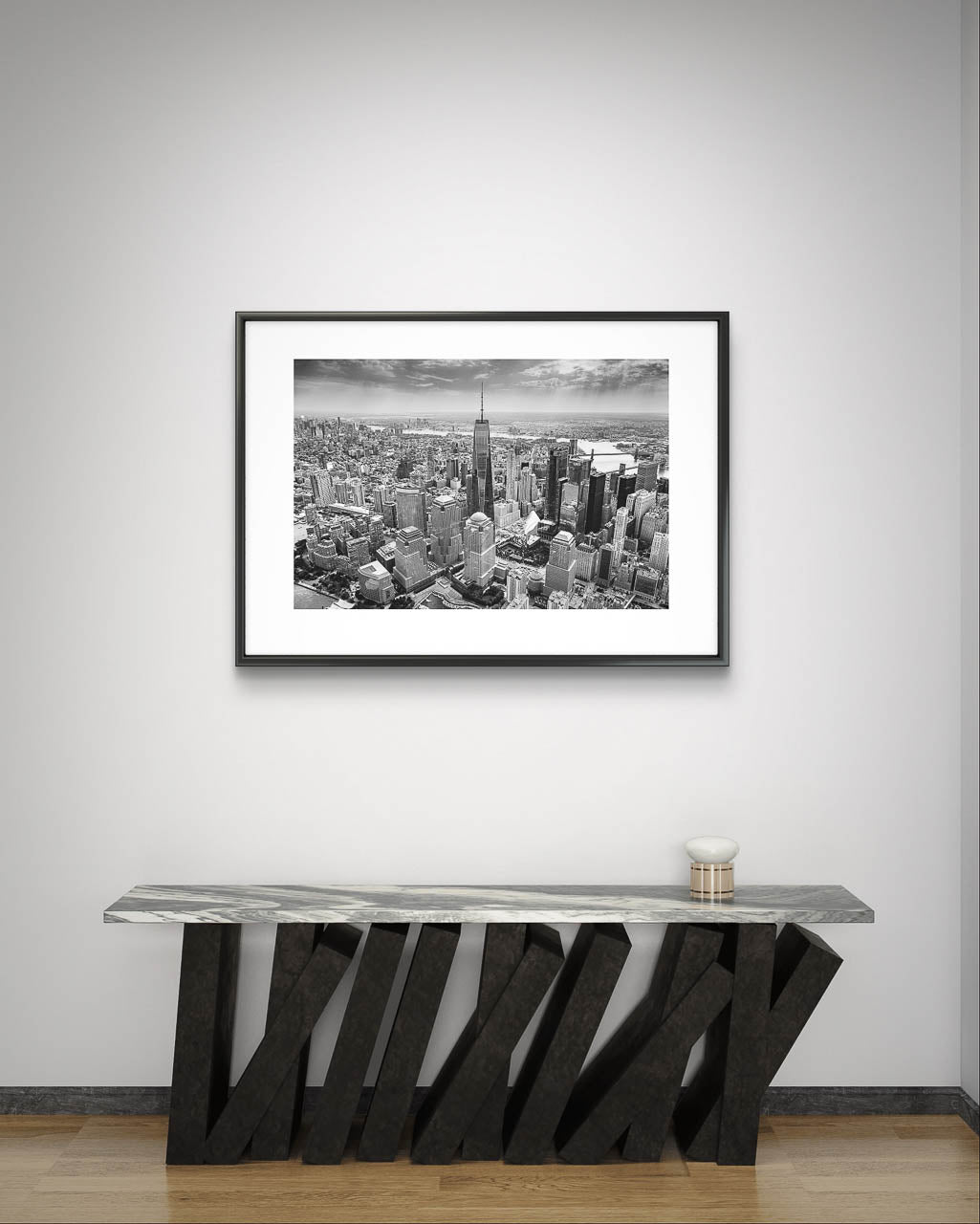 Modern table and minimalistic wall over it Black and white photograph of skyscrapers an buildings of New York City. Helicopter View. Focal point is One World Trade Center.
