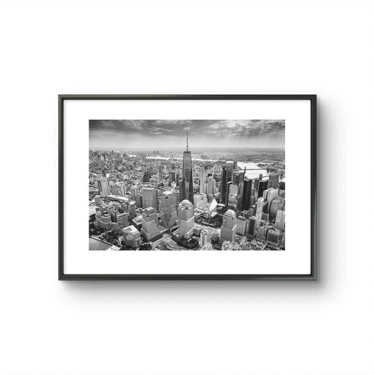 Framed Black and white photograph of skyscrapers an buildings of New York City. Helicopter View. Focal point is One World Trade Center.