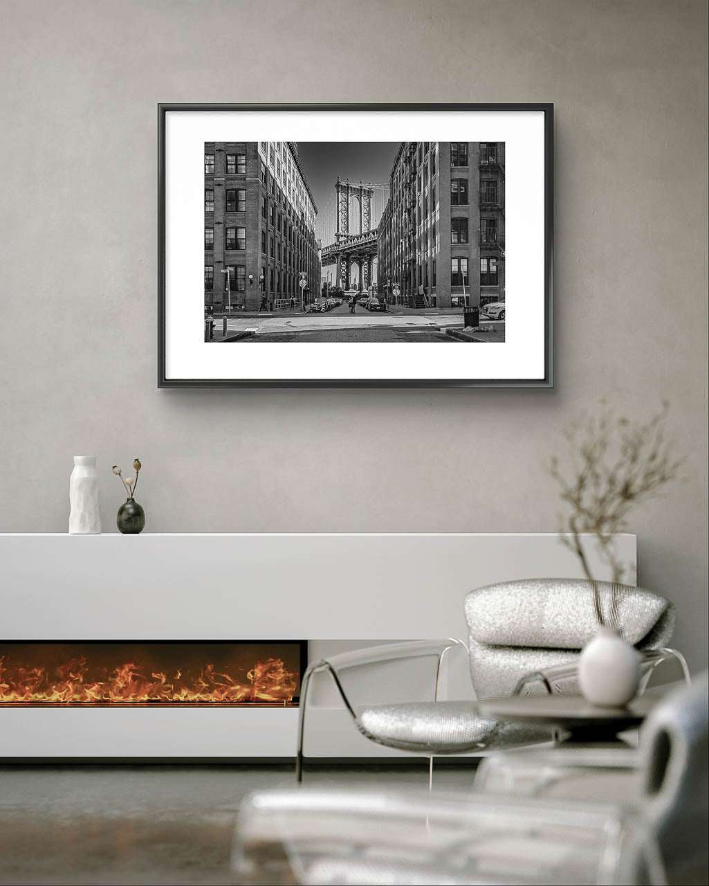 Living room in a modern home with an electric fireplace. Grey wall and on it Framed black and white photograph of Manhattan Bridge in between buildings. NYC. New York City.