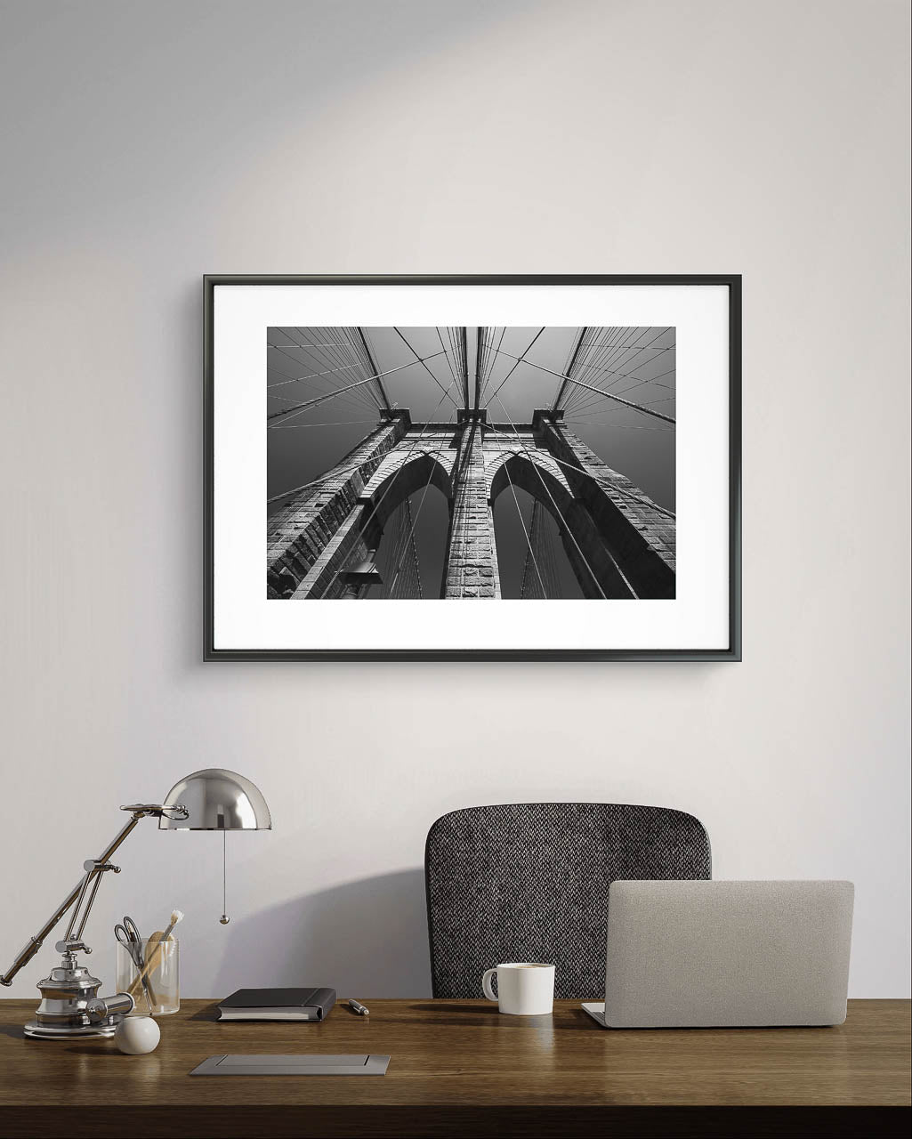in the office of CEO. A framed photograph of Brooklyn Bridge, fine art black and white print. Shot from the perspective of a pedestrian looking up, the image highlights the intricate Neogothic arches of one of the bridge's towers. Fine art photography print. Limited Edition, NYC, New York City, USA