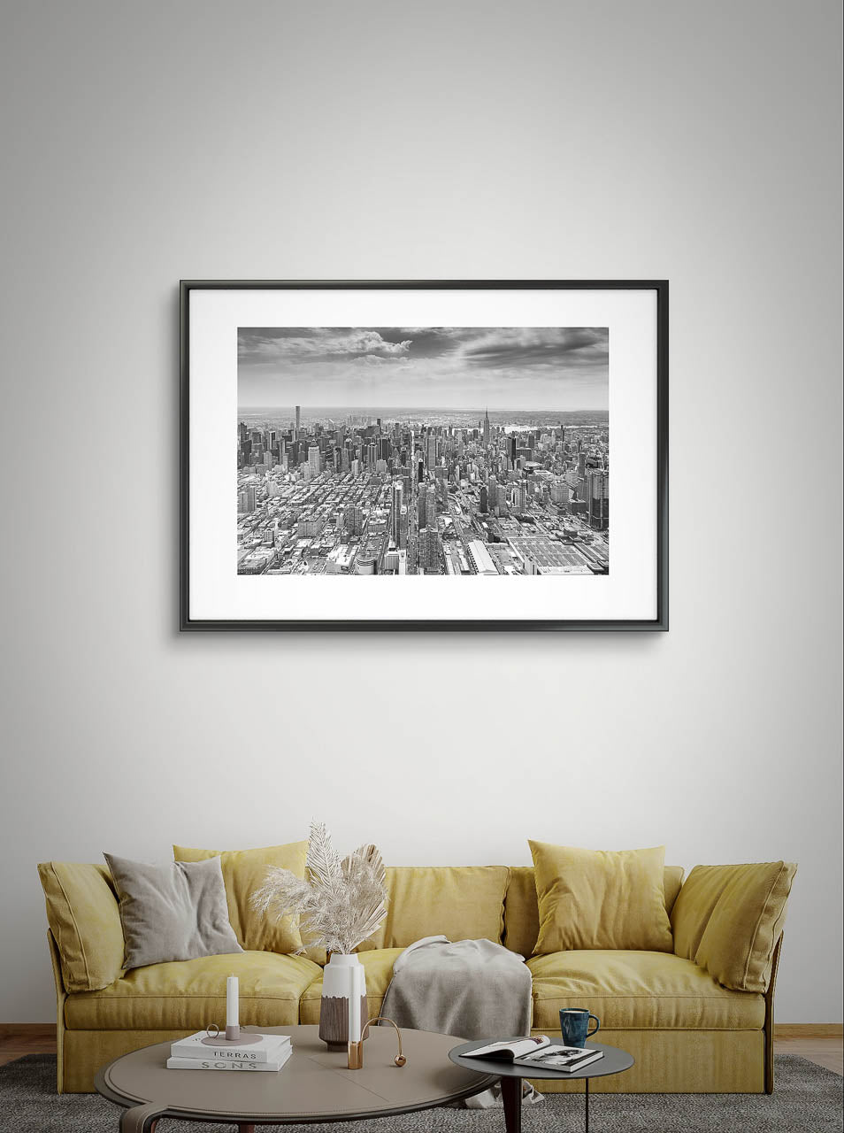 Living room with yellowish sofa and coffee table upfront. on the wall a photograph of Manhattan's iconic 42nd Street stretching for its entire two-mile length. Captured from a helicopter, Fine Art Photography Print. Limited Edition. New York City, NYC, USA, 42 Street.