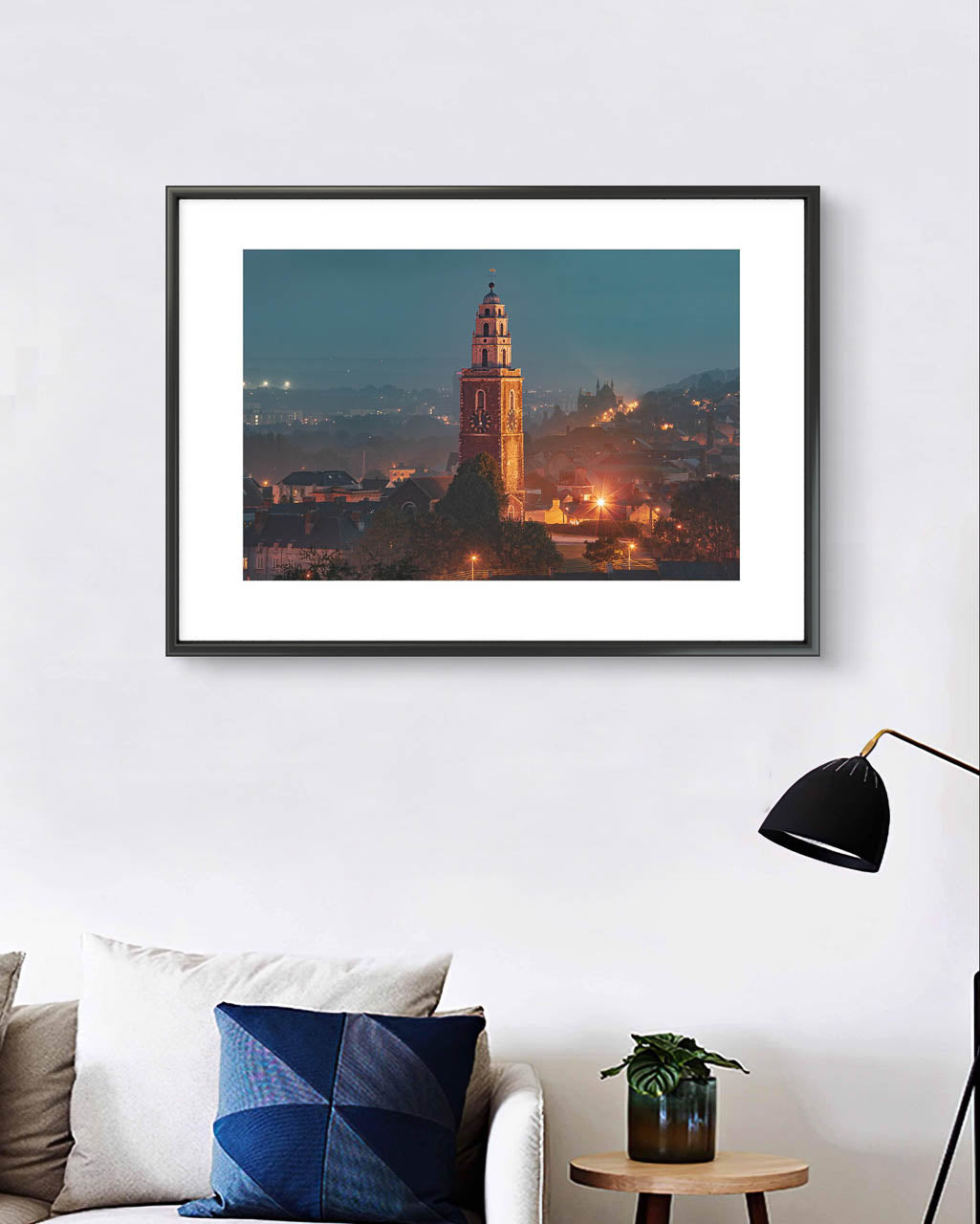 Living room with sofa, white wall. Fine Art photograph of St. Ann's Church/ Shandon Bells. At evening time. Foggy scenery. Long exposure effect, street lights. Limited Edition Print, The Four-Faced Liar,Cork City, Ireland