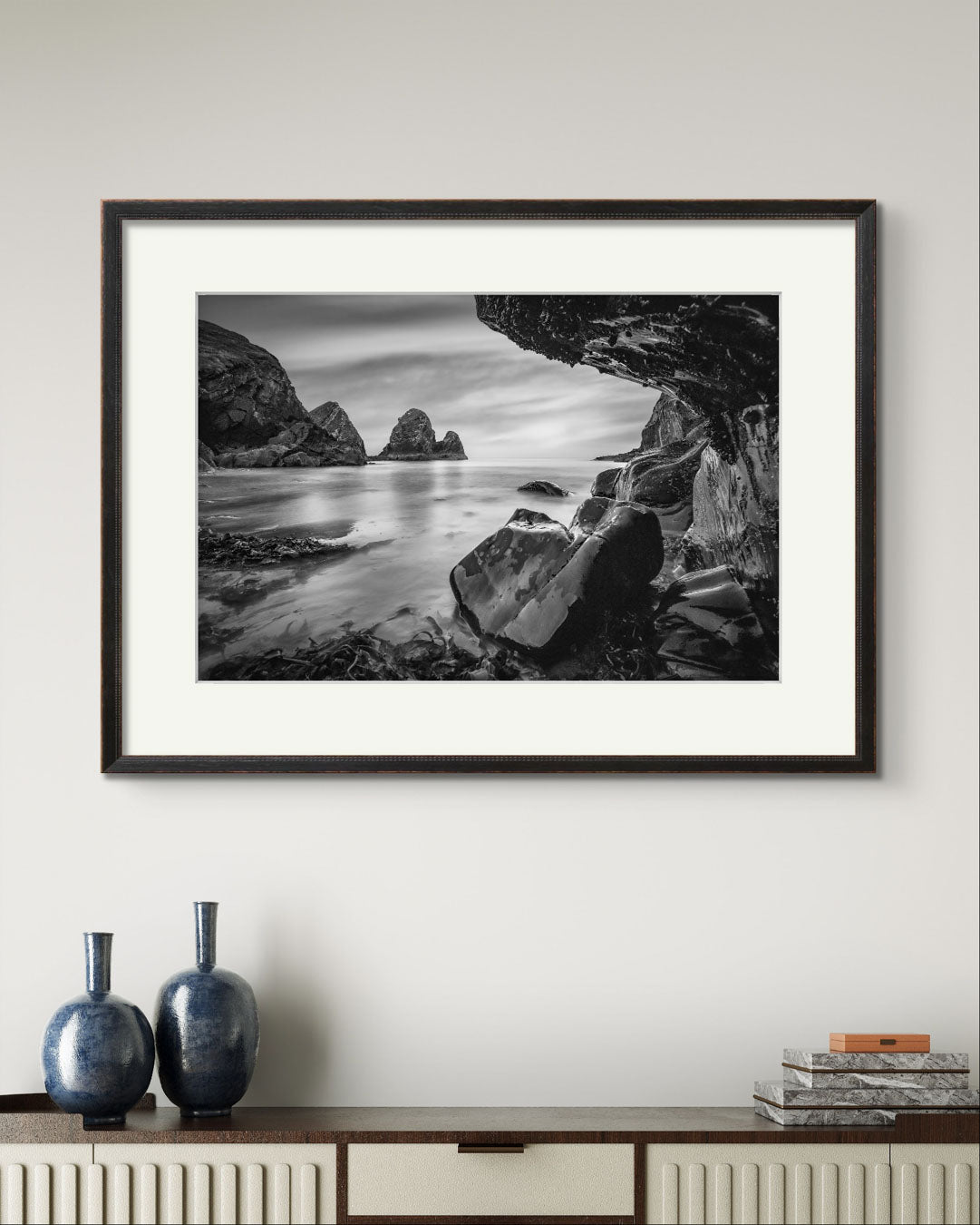 a framed Print of a Irish coastal landscape over a console table. Wild Atlantic Way. Cork Ireland.  Nohoval Cove