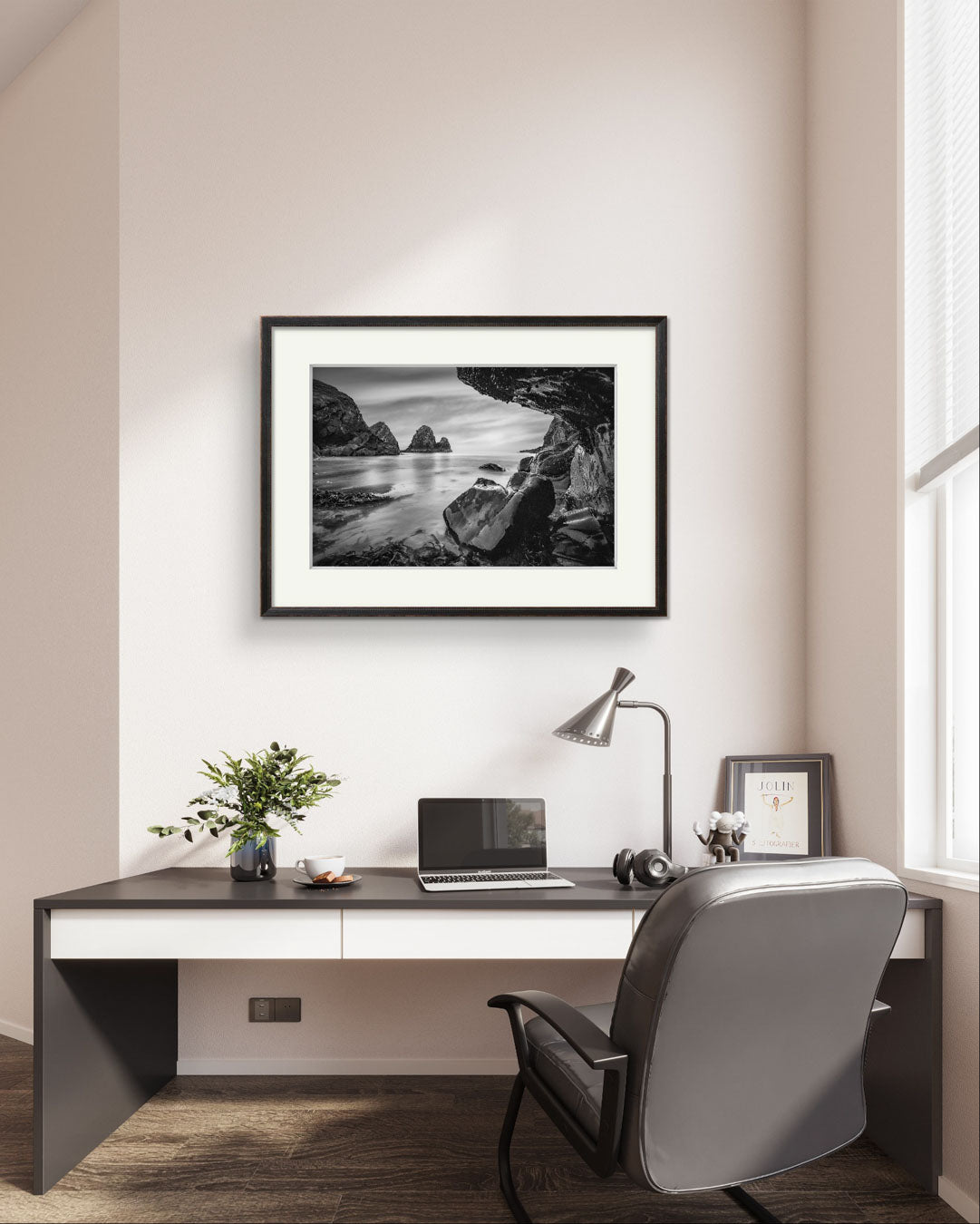 Nice office with desk and laptop on it. Framed Print of a Irish coastal landscape is hung above.Wild Atlantic Way. Cork Ireland.  Nohoval Cove