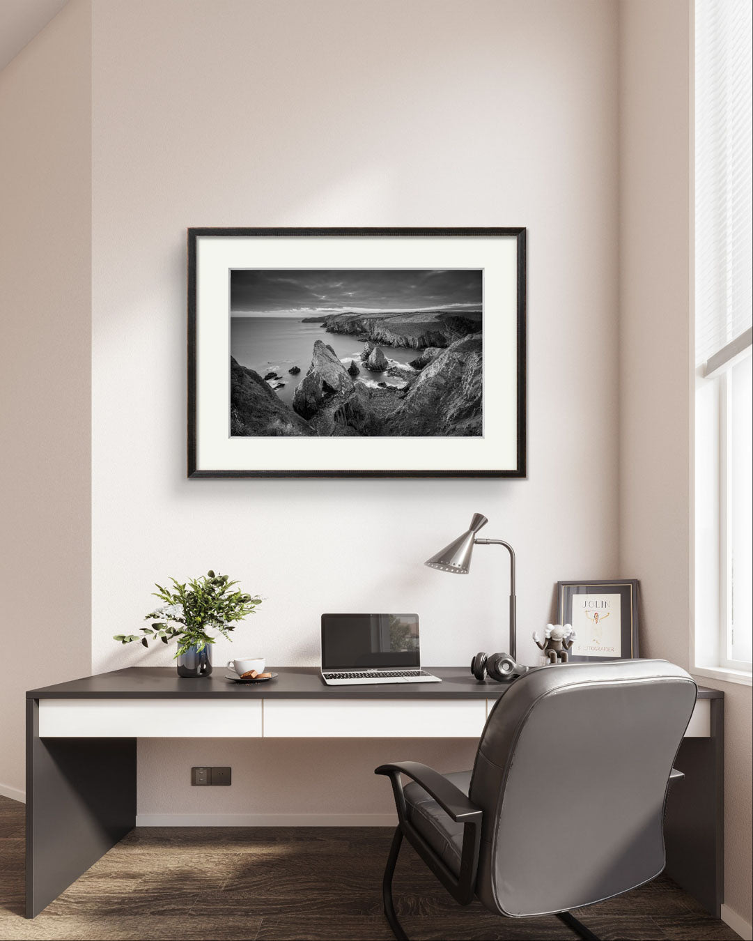 office with desk and chair. on the wall is large framed black and white photograph of Irish landscape. coastal view. Cork Ireland