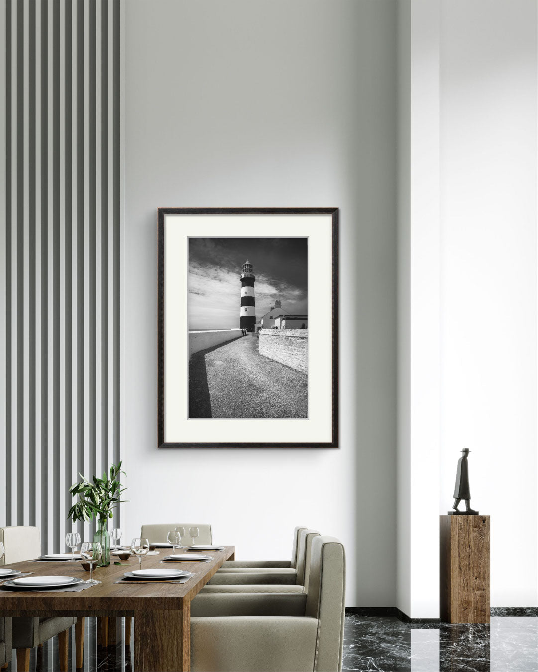 Dining table with table and chairs and in the back wall fine art photography print of a lighthouse on The Wild Atlantic Way. Cork. Kinsale. Irish coast.