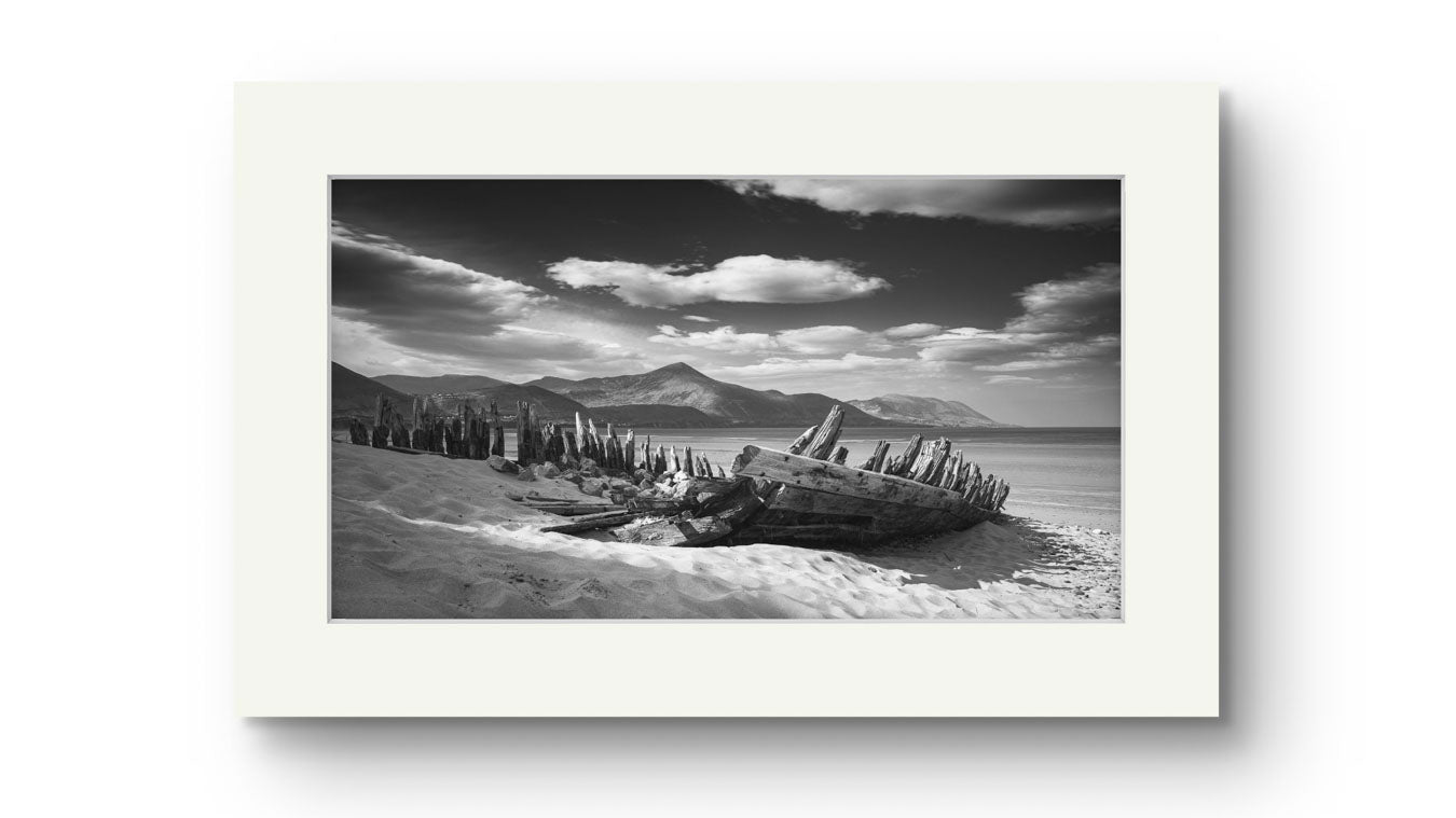 Print only. Irish coastal landscape. The wreck of ship in a focal point. behind hills and ocean. Wild Atlantic Way. Rossbeigh Beach. Kerry. Ireland.