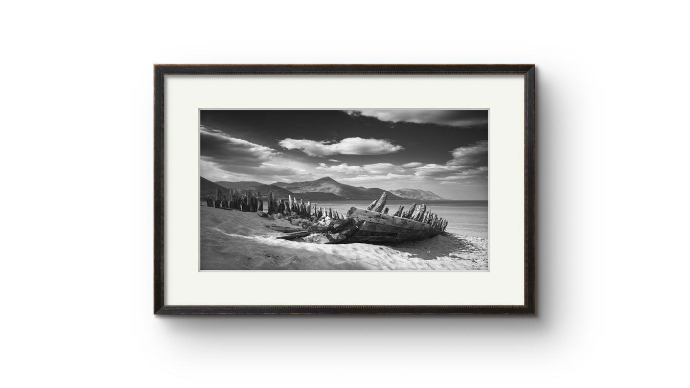 framed photography print of Irish coastal landscape. The wreck of ship in a focal point. behind hills and ocean. Wild Atlantic Way. Rossbeigh Beach. Kerry. Ireland.
