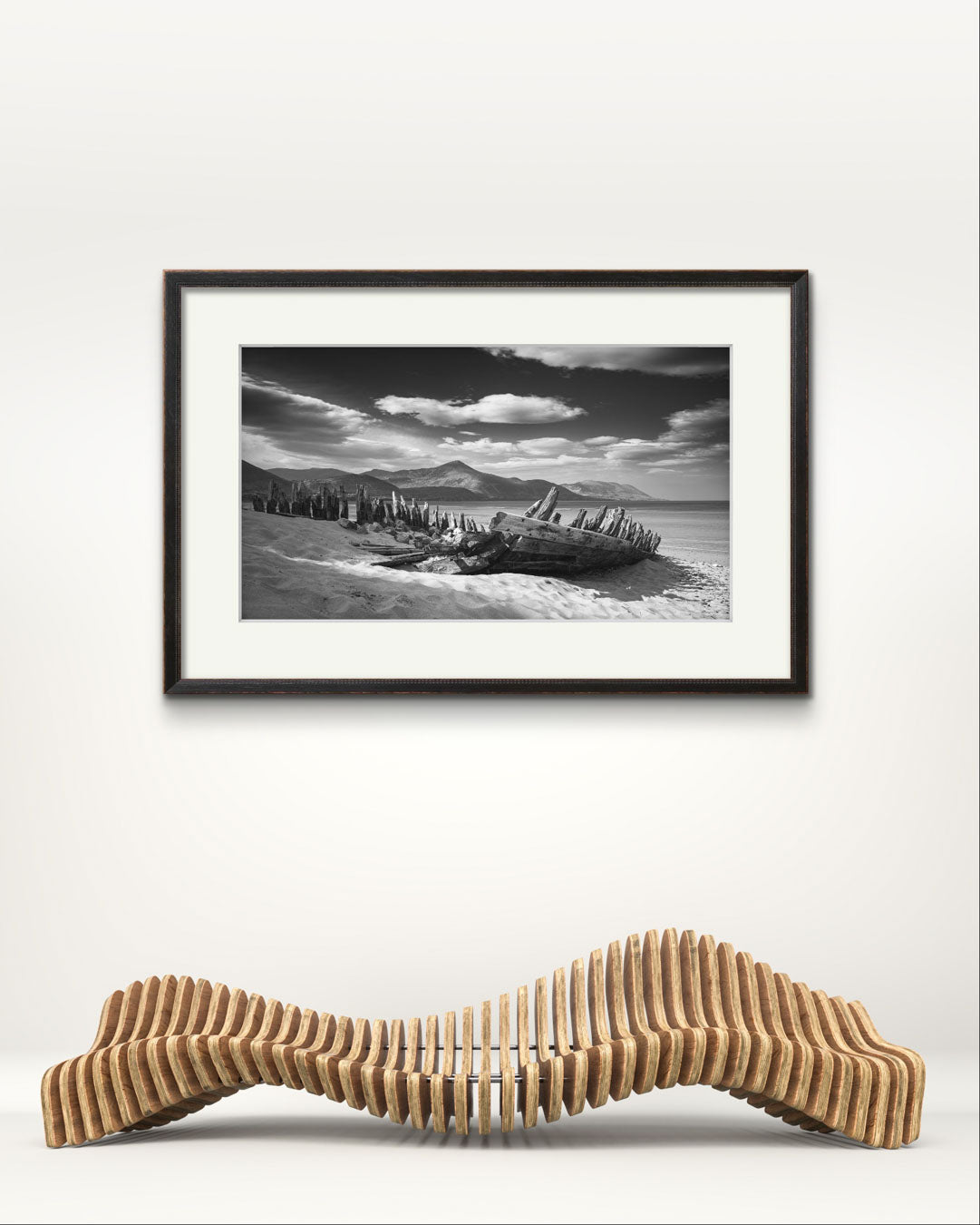 a museum bench with a framed photography print of Irish coastal landscape above. The wreck of ship in a focal point. behind hills and ocean. Wild Atlantic Way. Rossbeigh Beach. Kerry. Ireland.