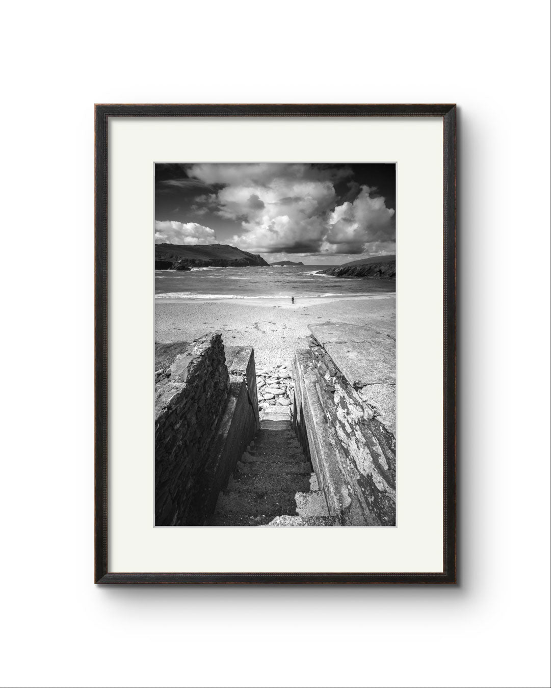 Framed photograph of an Irish Coast, dynamic composition draws your eyes to an ocean and a person walking on the distance beach. Clogher Beach. Dingle Town. Slea Head Drive in County Kerry.