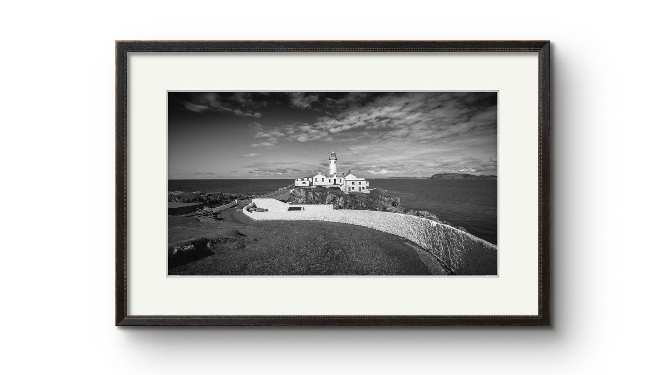 a framed photograph of Irish coastal landscape with a lighthouse in a focal point. Fanad Head. Donegal. Wild Atlantic Way.