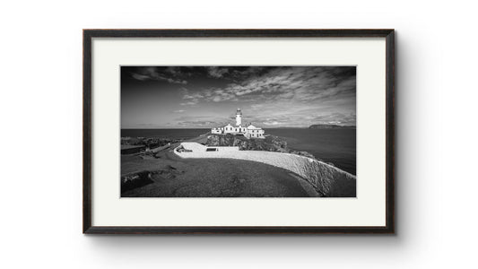a framed photograph of Irish coastal landscape with a lighthouse in a focal point. Fanad Head. Donegal. Wild Atlantic Way.