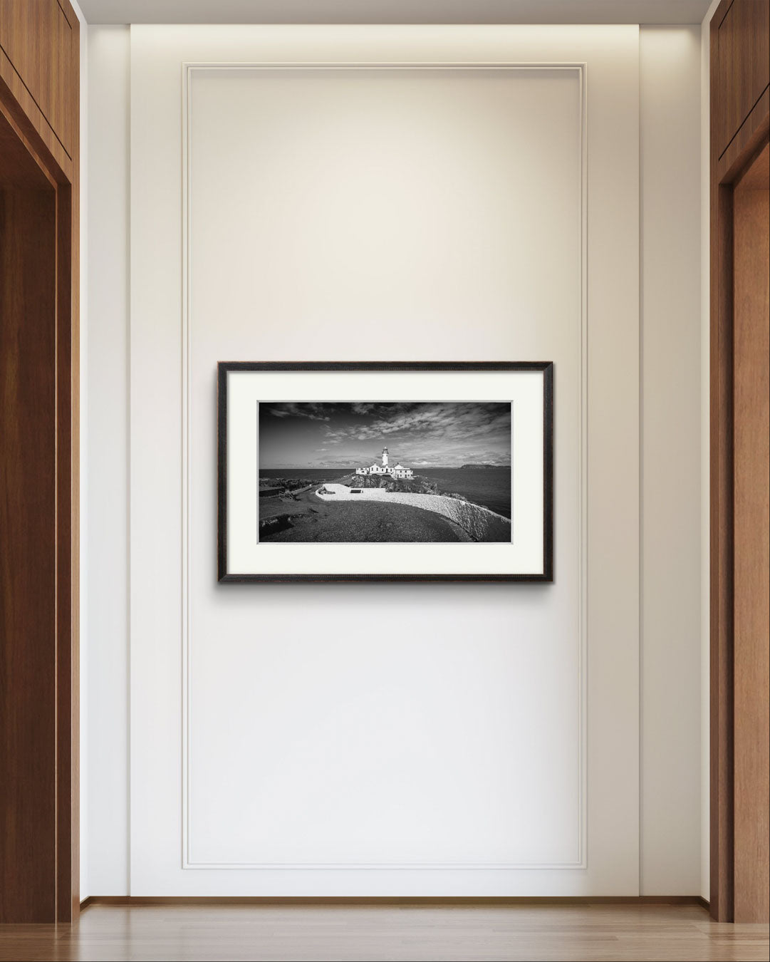 A hall and a framed photograph of Irish coastal landscape with a lighthouse in a focal point. Fanad Head. Donegal. Wild Atlantic Way.