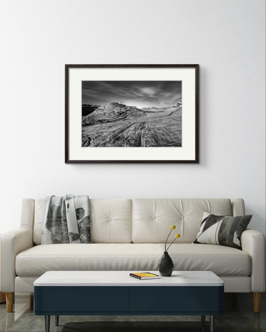 A white sofa with coffe table in a modern home living room. on the wall home decor wall art. fine art photography print. in black and white. A print of southern Nevada's Valley of Fire. Mojave Desert made of red Aztec sandstone. USA