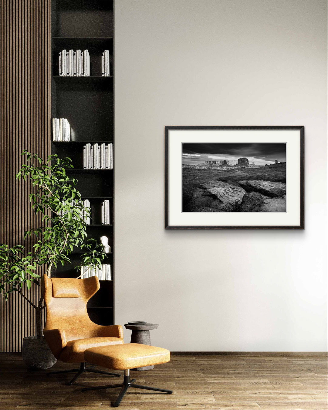 A meditation corner with a comfy chair. on the wall is large piece of modern home decor. Framed fine art photography print showcasing one of the most iconic and scenic spots in the Navajo Tribal Park in Monument Valley. Lookout with sweeping vistas of craggy buttes. USA