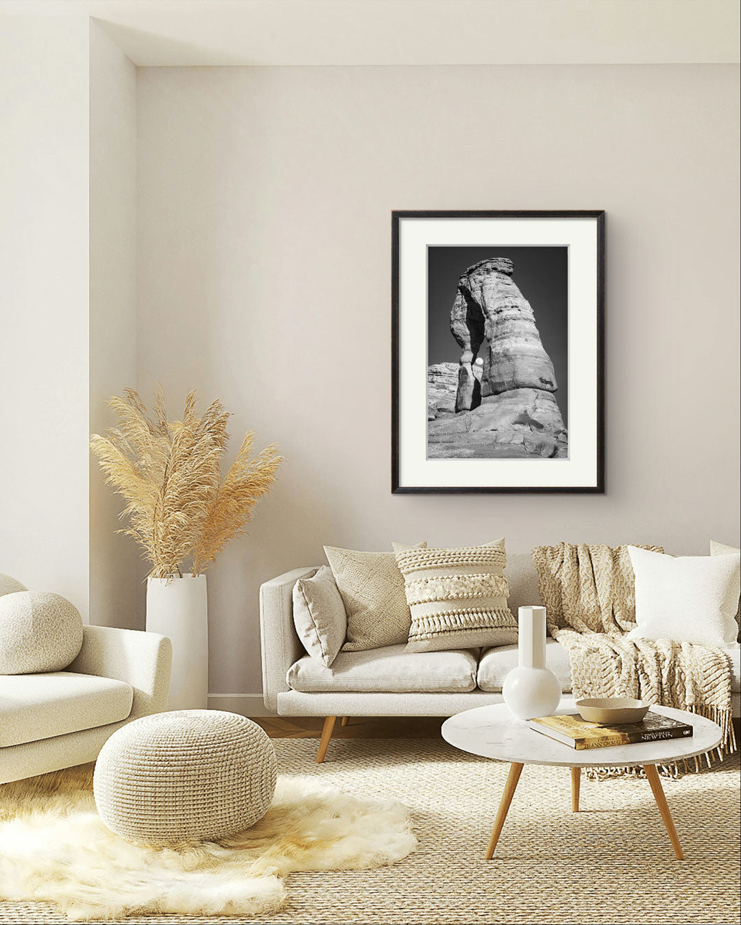 modern living room settings with hanging  Framed Fine Art black and white photograph of impressive large arch  and visible moon through it. Delicate Arch, Moab, USA, Arches National Park