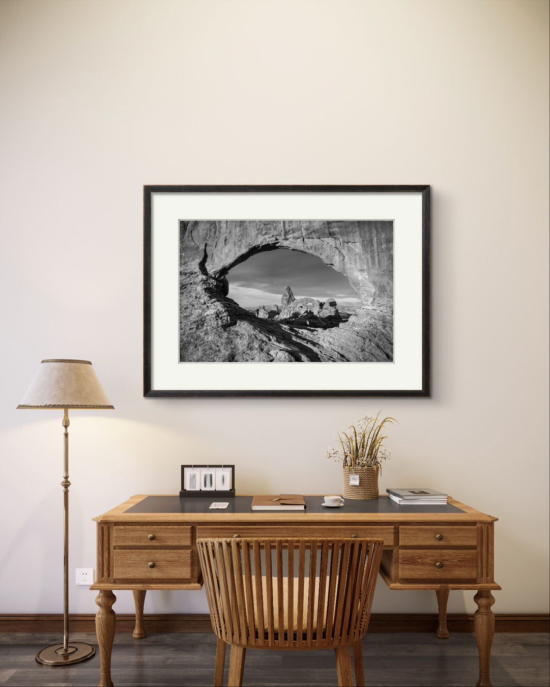 Retro desk and retro chair with large home decor wall art. Fine art photography print of Arches National Park, Utah, United States. Turret Arch. Rock arch. View of Turret Arch. Moab, Utah, USA