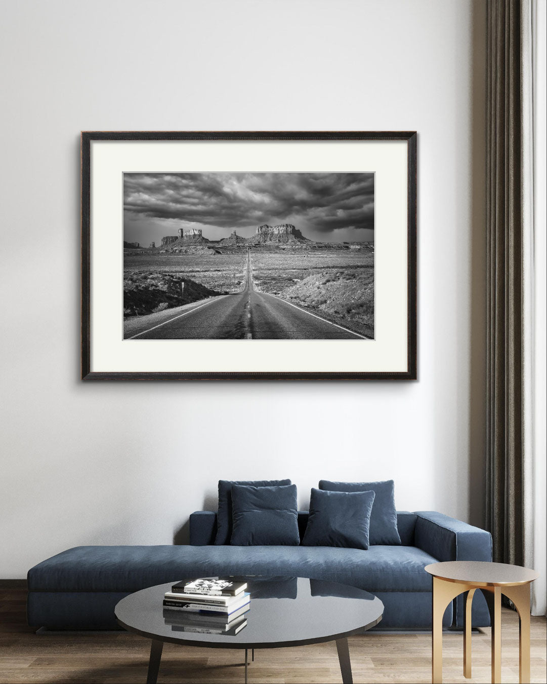 A comfy sofa with a coffee table, a stack of books Black and white Photograph of a famous Forrest Gump Point. US Scenic Highway 163.  Navajo Reservation. Monument Valley. USA