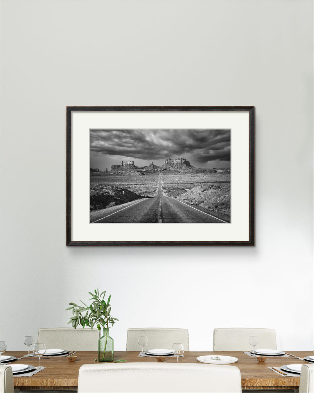 A posh dining table and a large wall art. Black and white Photograph of a famous Forrest Gump Point. US Scenic Highway 163.  Navajo Reservation. Monument Valley. USA