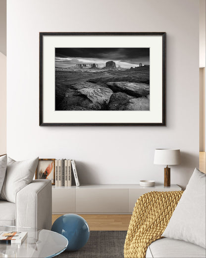 a bright living room with a modern home decor elements. Large wall art of a framed fine art photography print showcasing one of the most iconic and scenic spots in the Navajo Tribal Park in Monument Valley. Lookout with sweeping vistas of craggy buttes. USA