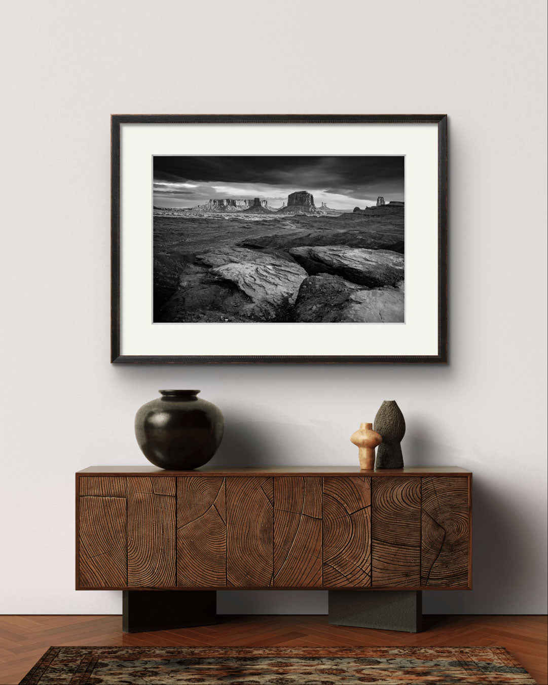 A retro console table . Above is Framed fine art photography print showcasing one of the most iconic and scenic spots in the Navajo Tribal Park in Monument Valley. Lookout with sweeping vistas of craggy buttes. USA