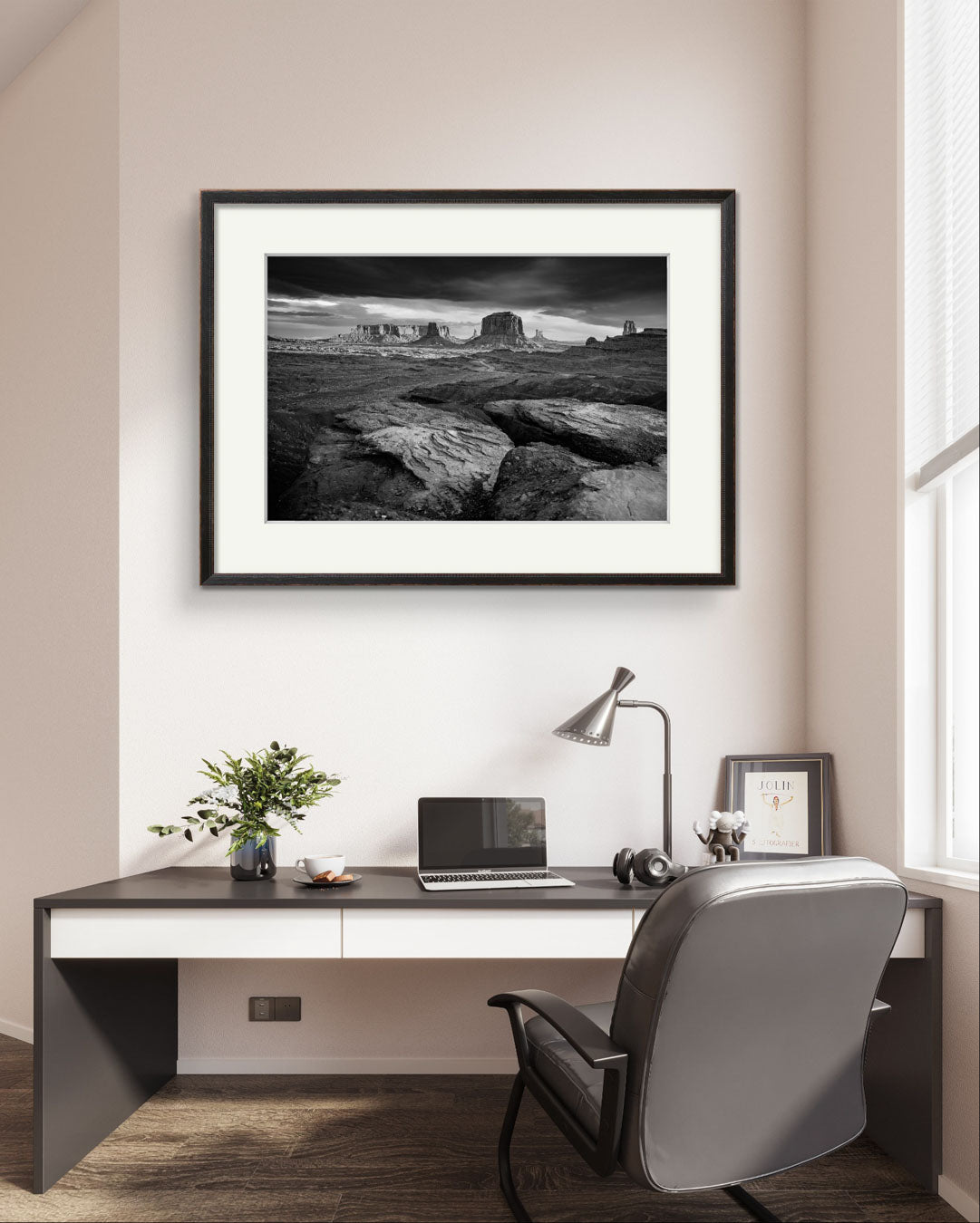 new office. on the wall a large piece of wall art. Framed fine art photography print showcasing one of the most iconic and scenic spots in the Navajo Tribal Park in Monument Valley. Lookout with sweeping vistas of craggy buttes. USA